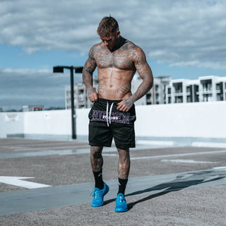 muscle shot of bloke wearing blue trainers