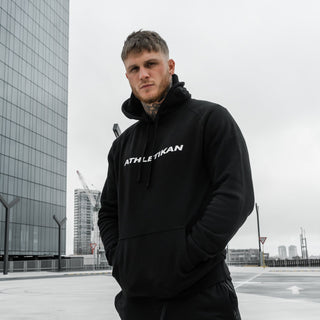 model wearing mens black hoodie in car park