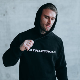 plain black hoodie on tattooed model